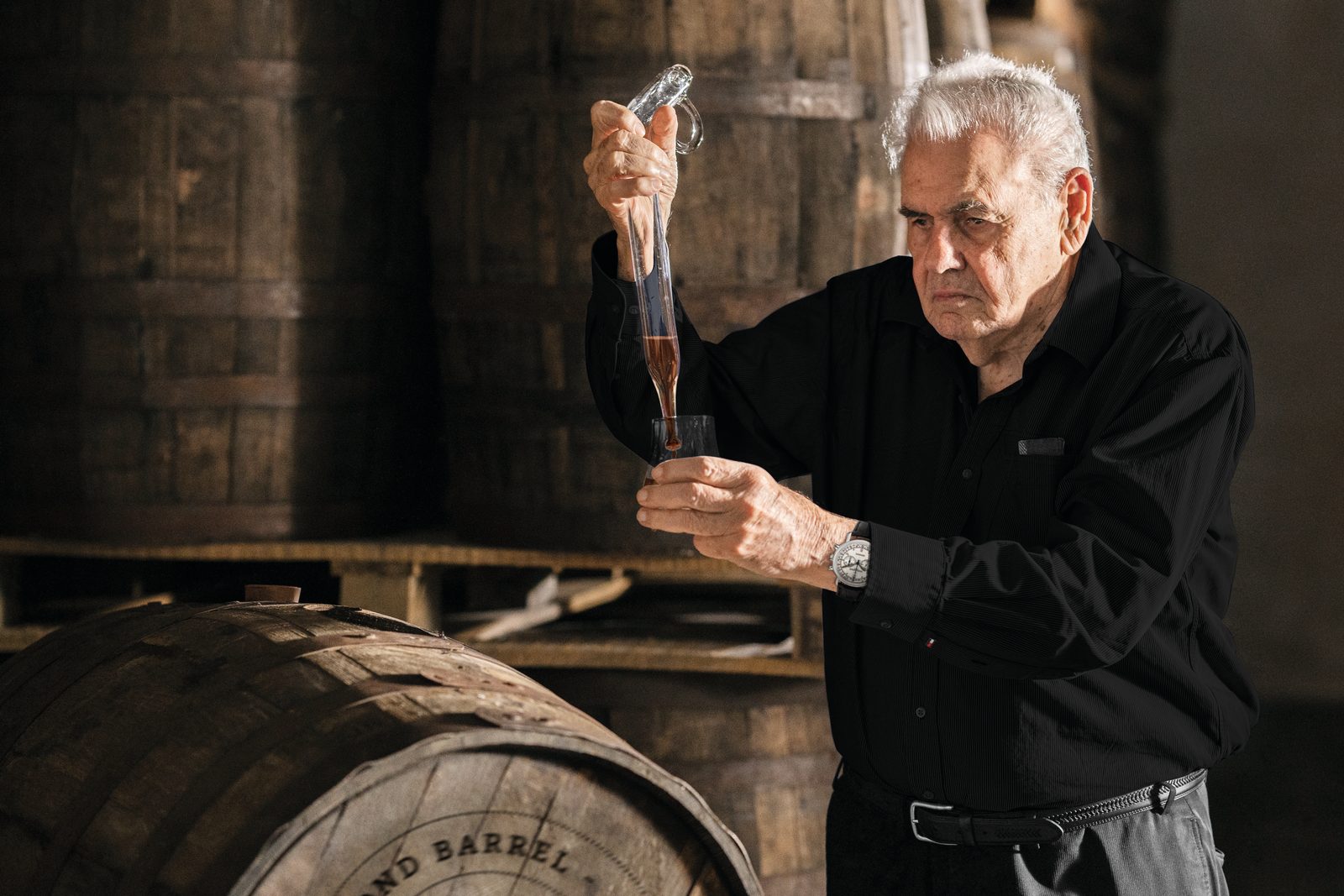 Don Pancho drawing rum from a cask